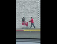 Woman selfie video seated on a pushcart sidewalk
