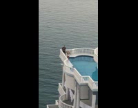 Woman white bikini pool rooftop balcony drone