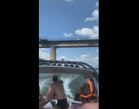 Guy grabs cable from boat swings bridge 