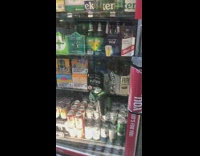 Guy sleeps on cases of drinks in shop