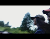 Girl rides motorcycle and hits a bump while recording video selfie