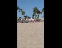 Man pink shorts dance tiktok video shoot beach