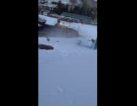 Man on Sled Descends Snow Slope Fast