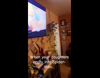 Kid dress up as Spiderman watch movie