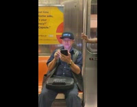 Man wears marquee hat that says God does not exist blue text