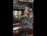 Rat costume guy crouches on subway entrance 