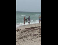 Bikini Girl catches poses with swordfish beach 