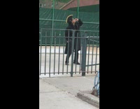 Black pirate hat guy smokes cigarette outside 