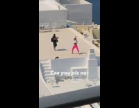 Girl pink leggings dance on rooftop Santorini