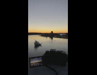 Timelapse of dusk sky above town by lake
