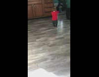 Baby boy imitates preaching raises one arm 