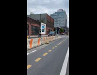 Collab WINY - Man ride bike balance tire on head left side of the road concrete barriers