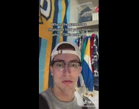Guy white hat glasses in closet talking