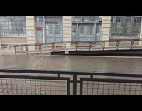 Car drives by flood at Sunset Park