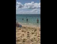 girl films herself in the ocean