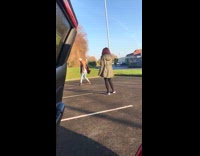 Guy brown coat exaggerated poses parking lot