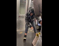 Man bent over holding onto subway pole