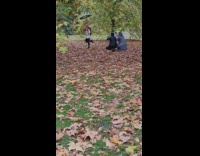 Girl beanie jacket pour leaves with umbrella