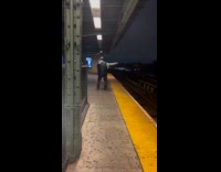 Man black vest dance train station night