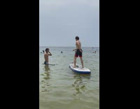 Guy jumps on surfboard then falls into water 