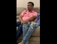 Guy rubbing friends knee ripped jeans 