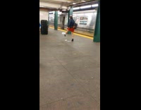 Woman kicks around plastic bag subway station