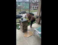 Girl brown hoodie on porch leaning over