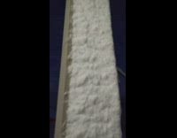 Snow stick vertically on porch column night