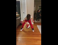 Two kids practicing dribbling playing with basketball in living room