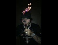 NSFW guy lights head on fire and smokes