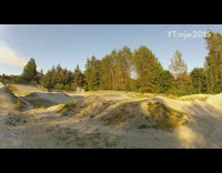 Guy rides electric mountain bike off ramp and lands on front wheel, face plants