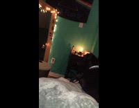 Black dog sees its reflection in mirror, then barks and growls at it