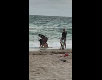 Kids watch two women butt beach hat