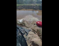 Guy fails to ride tube on water slide into pond