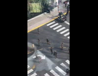 Two zombie extras dance on street during filming