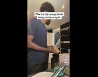 Guy washing dirty plastic container throws it into trash can 