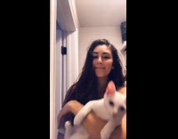 Girl dancing with cat to Lemon song inside closet