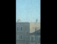 Shirtless guy black shorts handstand rooftop photo 