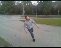 Guy in grey sweatshirt tries a karate kick and falls. 