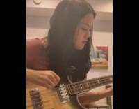 Woman plays bass guitar friend sings