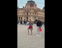 fancy woman takes selfie near old building