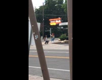 girl on knees under sour duck sign