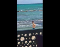 Guy blue shorts slow motion run beach