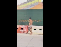 Man walking on street wearing underwear only