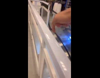 Guy fingers pretending to run on white rail in mall