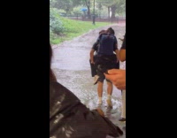 Man gives girlfriend piggyback ride through tunnel flood 