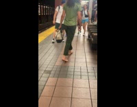 Woman green shirt walk barefoot in subway