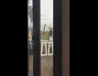 Two girls selfie restaurant patio orange shirt