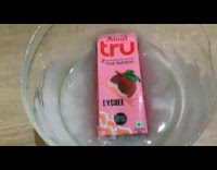 Guy freezes juice box on a container 