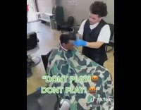 Guy tries to sit on lap barber 